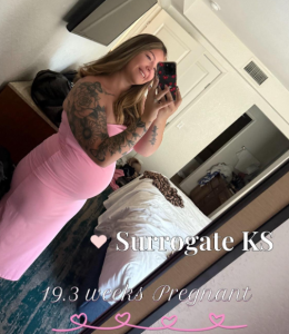 A happy surrogate mom for Babytree Surrogacy shows her baby bump at 19.3 weeks, sharing her journey with pride and excitement. babytree