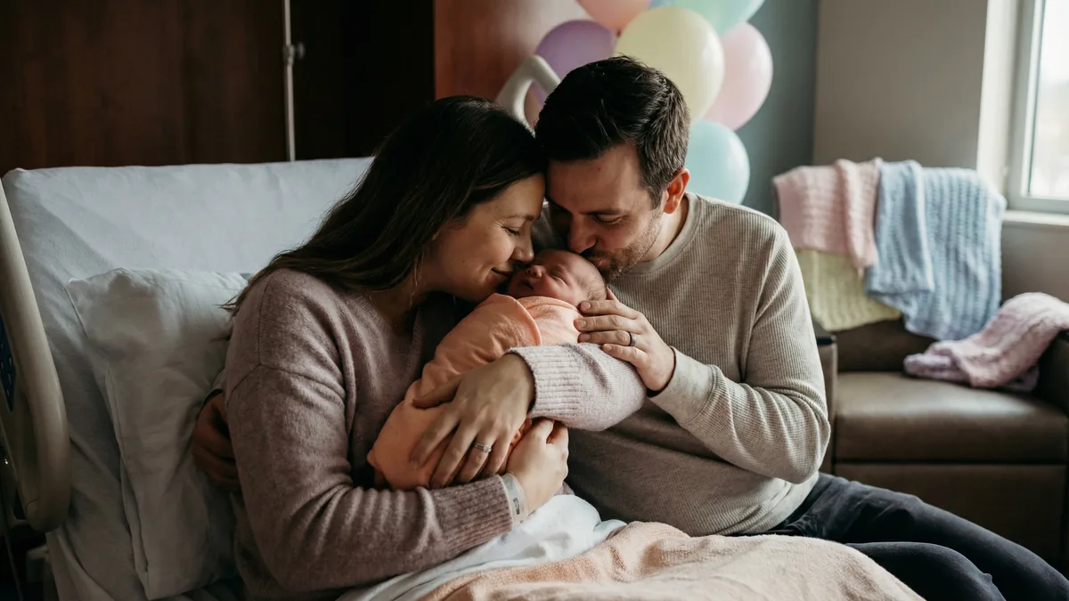 Babytree Surrogacy shows happy parents welcoming their newborn at the hospital, showing love and excitement for their new family. babytree