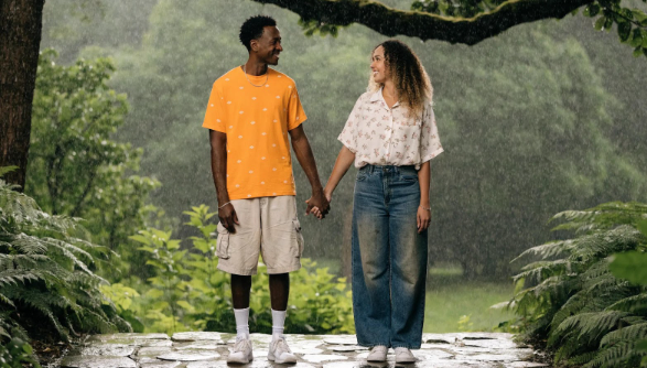 A happy couple enjoys a joyful moment together in the rain, representing new beginnings with Babytree Surrogacy. babytree